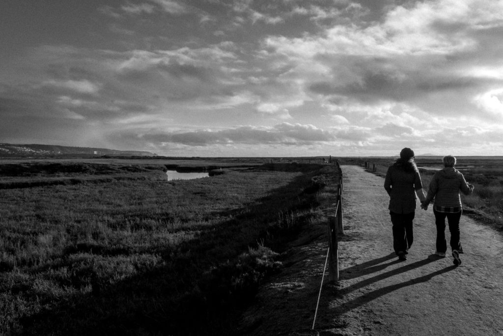 Two people walk along the South McCoy trail path