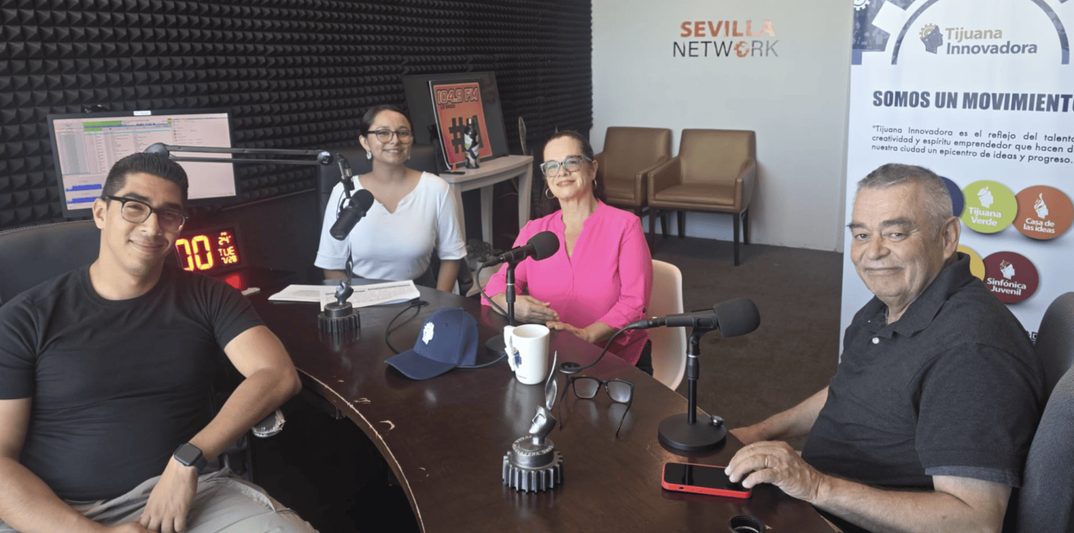 Four people in a radio studio during a broadcast.