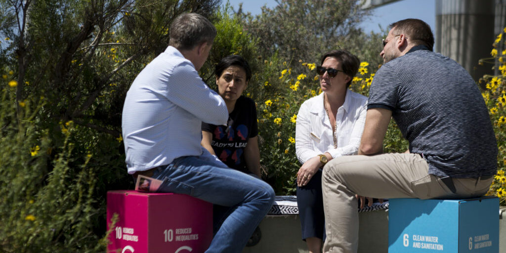 group of people sitting outside having a conversation