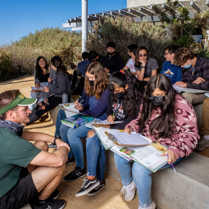 Students and instructor working on an assignment outside of the Tijuana Estuary Visitor Center Students and instructor working on an assignment outside of the Tijuana Estuary Visitor Center