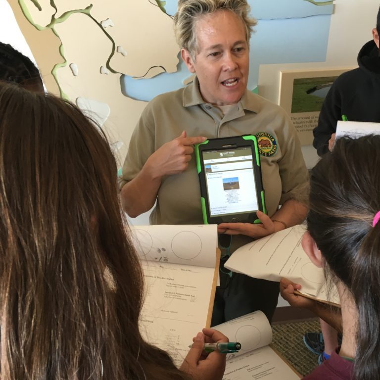 CA Parks Employee leading a school program A California State Parks employee leads a program for students at the Tijuana Estuary Visitor Center